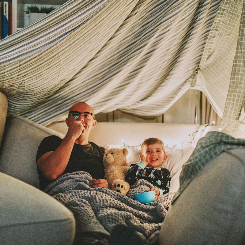 padre e hijo viendo una película felices