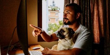 Chico con su perro mirando el ordenador